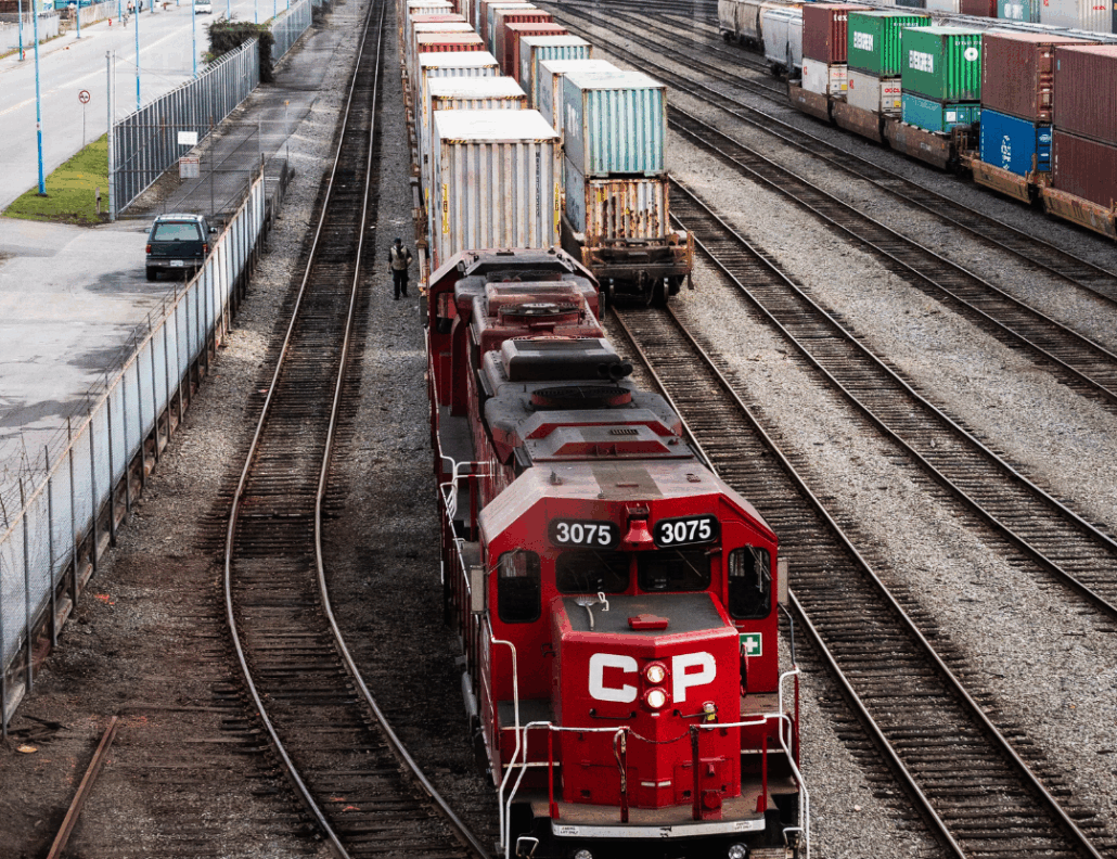 Red and White Train on Rail Tracks