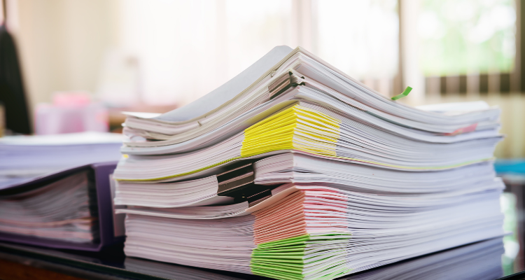 Stack of Organized Documents on Office Table - RISQS audit