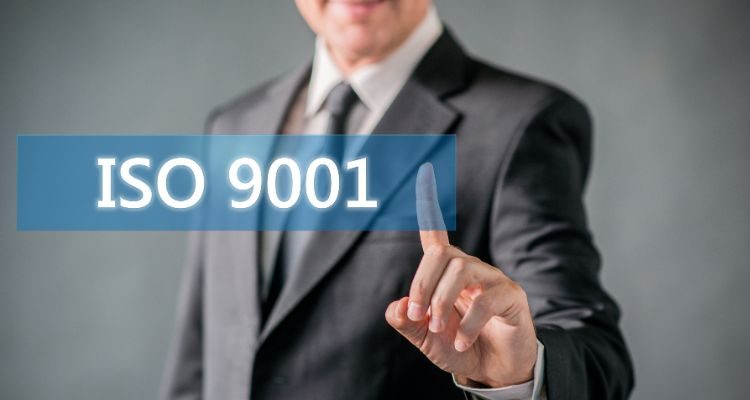 A man points to the ISO9001 logo